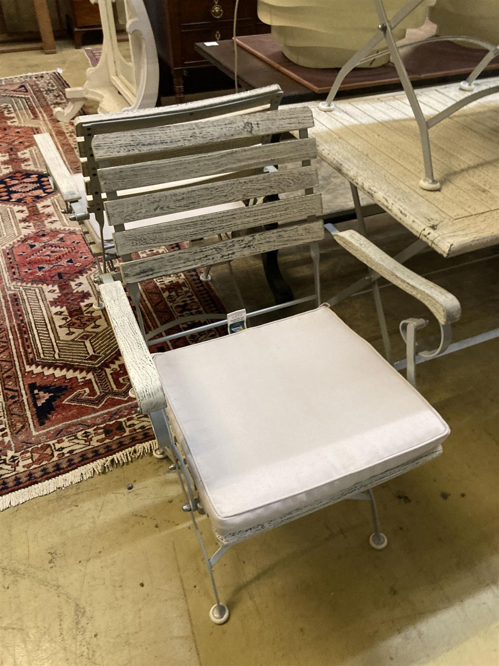 A modern painted slatted wood and metal garden suite of folding table, width 120cm, depth 72cm, height 75cm, bench and a pair of elbow